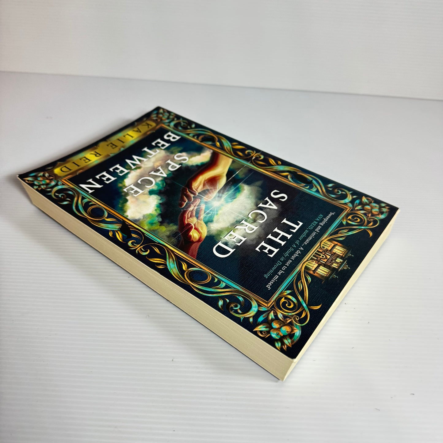 The Sacred Space Between - Kalie Reid