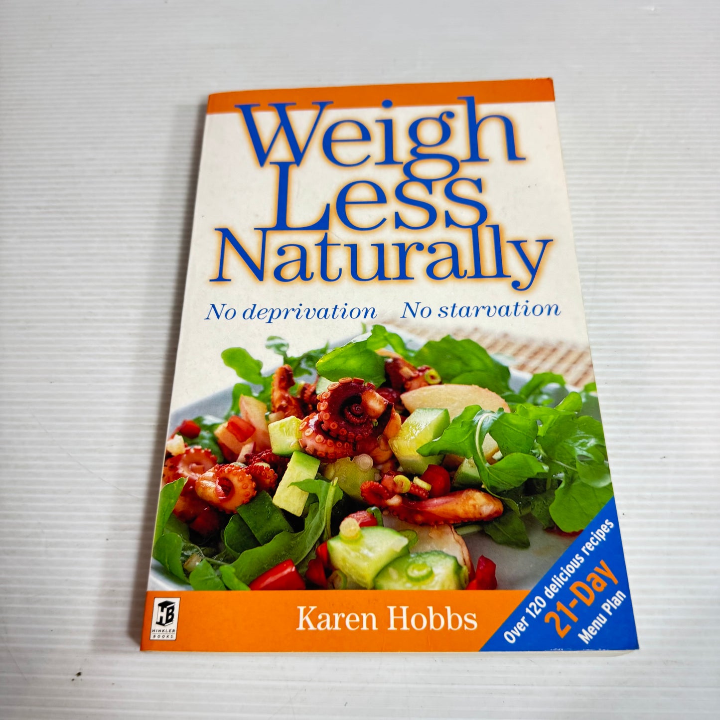 Book titled 'Weigh Less Naturally' by Karen Hobbs on a white background