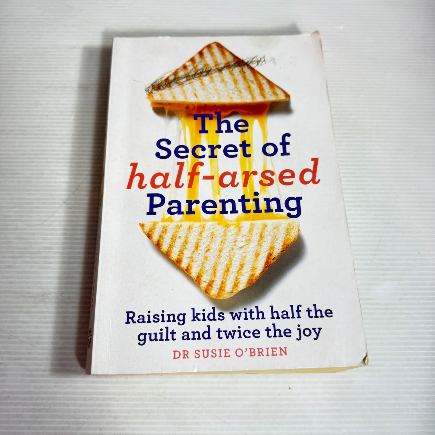 The Secret of Half-Arsed Parenting : Raising Kids with Half the Guilt and Twice the Joy - Dr Susie O'Brien