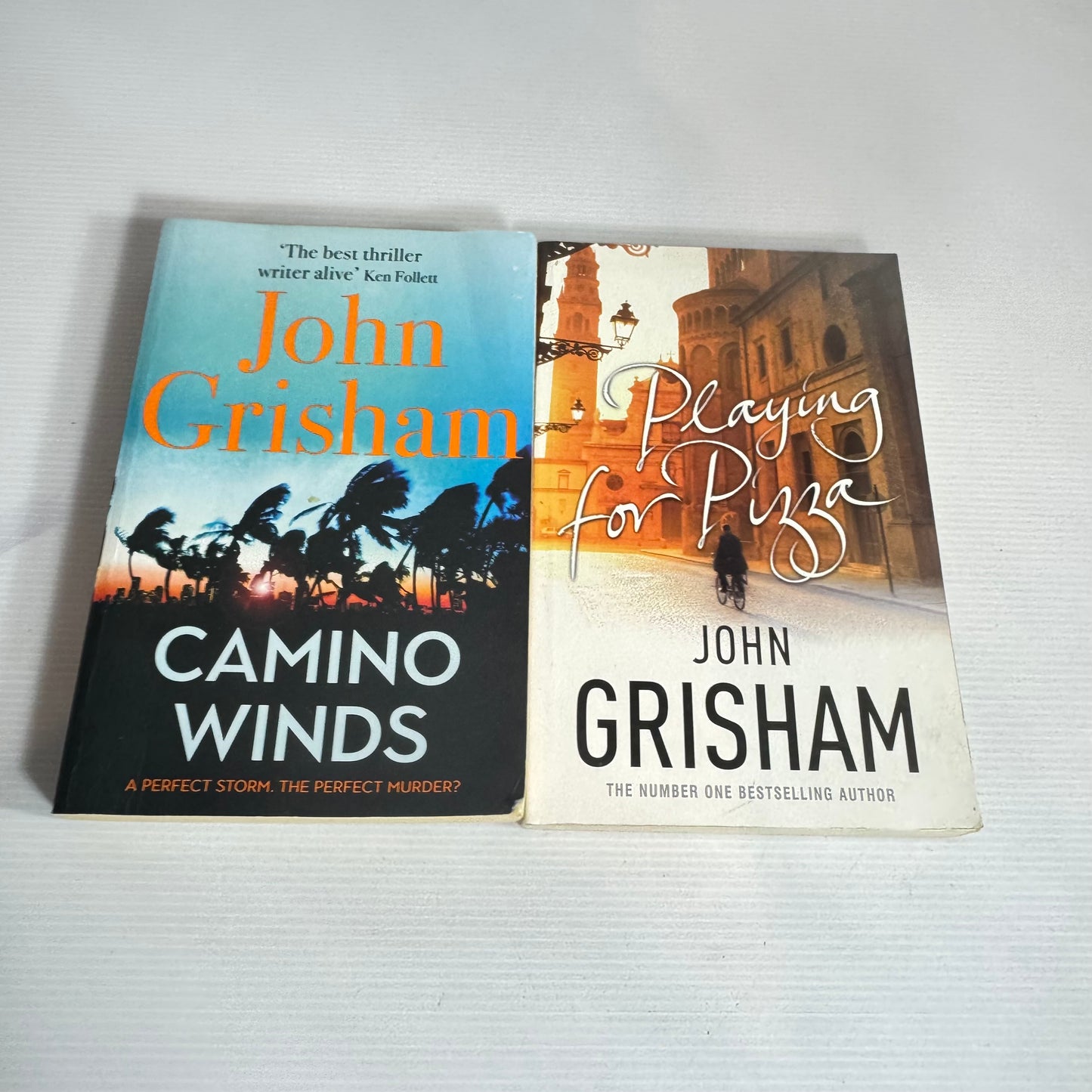 John Grisham Book Bundle x 2 : Playing for Pizza & Camino Winds (2430)